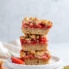 strawberry crumble bars in a stack on a plate