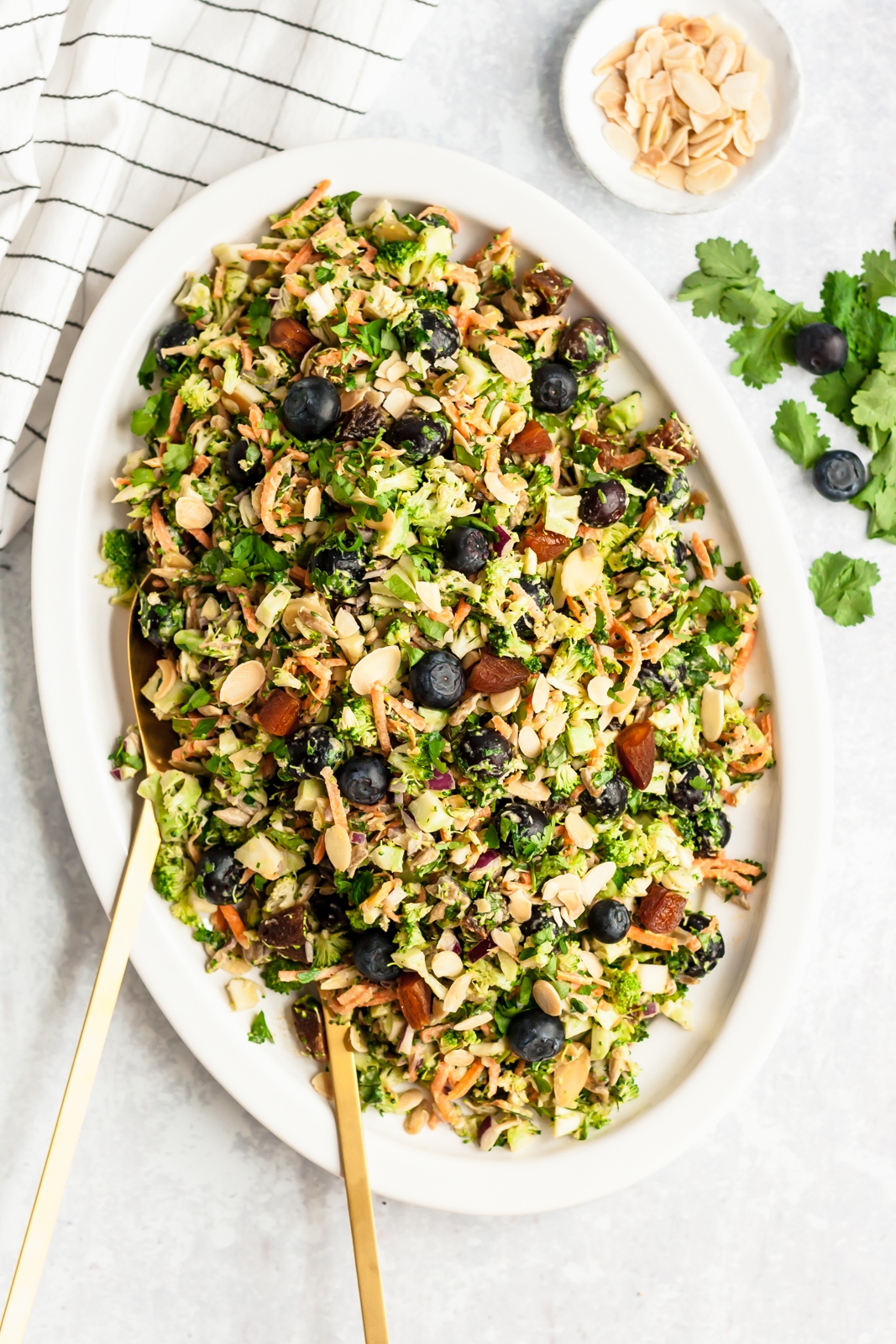 healthy broccoli salad with blueberries and toasted almonds on a platter