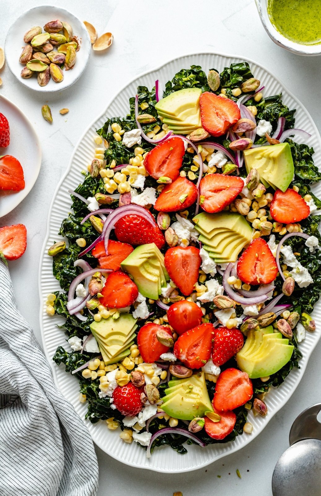 strawberry kale salad with strawberries on a platter