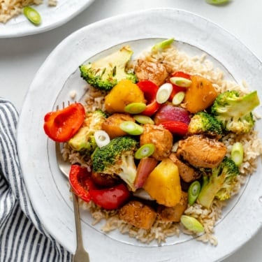 healthy sweet and sour chicken stir fry with broccoli and pineapple on a plate