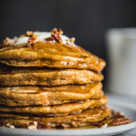 sweet potato pancakes in a stack on a plate