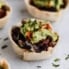 black bean taco cups with guacamole and hot sauce