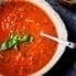 Homemade roasted tomato basil soup in a bowl with a spoon
