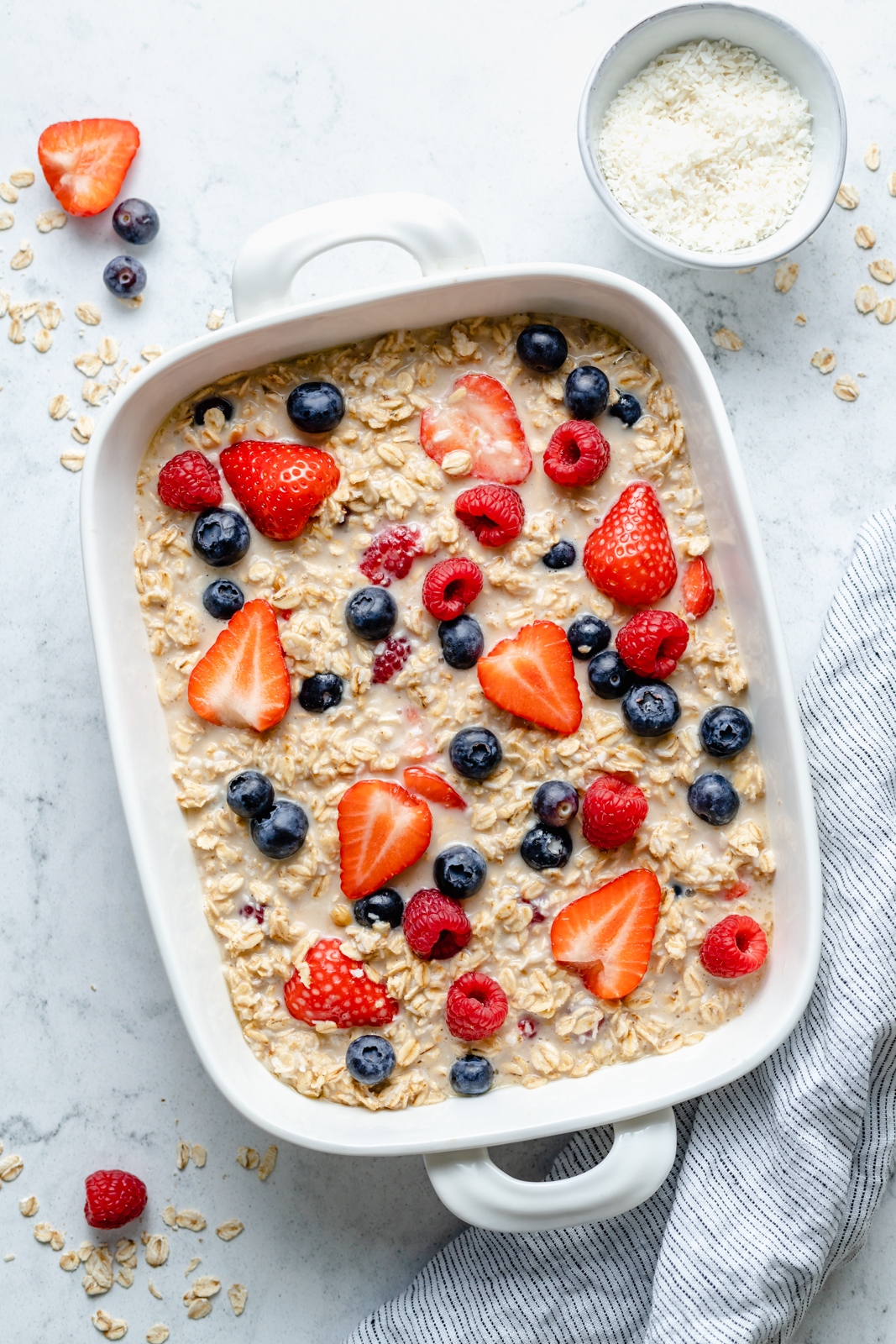 unbaked berries and cream baked oatmeal in a baking dish