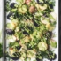 vegan potato salad drizzled with green tahini sauce on a tray