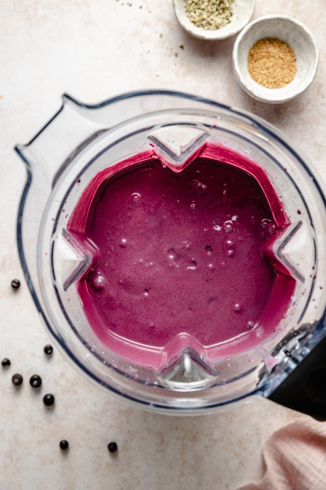 top-down view of a wild blueberry smoothie in a blender